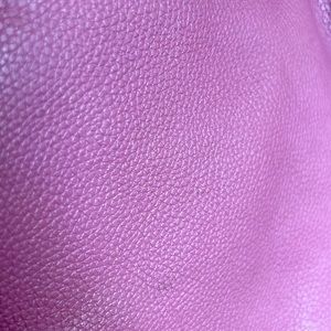 Beautiful and soft light pink leather shoulder bag with a crossbody strap.